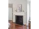 Elegant fireplace with detailed mantle and black firebox complements the wood floors at 11 Church St, Charleston, SC 29401