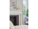 Close-up of fireplace with decorative mantel, framed print, and natural light at 11 Church St, Charleston, SC 29401