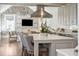 Bright kitchen boasts marble counters, brick accent wall, Viking range, and stylish island seating at 11 Church St, Charleston, SC 29401