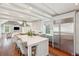 Bright kitchen features wooden floors, exposed beams, marble counters, and stainless appliances at 11 Church St, Charleston, SC 29401