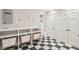Well-organized laundry room with ample shelving and black-and-white tile flooring at 11 Church St, Charleston, SC 29401