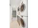Well-equipped laundry room features stainless steel appliances, stacked washer and dryer, and tile flooring at 11 Church St, Charleston, SC 29401