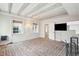 Bright living room features wood beam ceiling, brick floor, and neutral colors at 11 Church St, Charleston, SC 29401