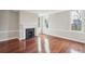 An elegant living room with hardwood floors, a fireplace, and bright windows at 11 Church St, Charleston, SC 29401