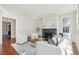 Bright living room features fireplace, white sofa, chairs, and decorative rug at 11 Church St, Charleston, SC 29401