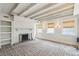 Spacious living room with brick floor, fireplace, exposed wood beams, and natural light at 11 Church St, Charleston, SC 29401
