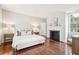 Bright main bedroom featuring hardwood floors, a fireplace, and neutral decor at 11 Church St, Charleston, SC 29401