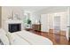 Stylish main bedroom featuring a fireplace and entry to an ensuite bathroom at 11 Church St, Charleston, SC 29401