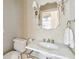 Elegant powder room boasts patterned wallpaper, a marble countertop, and stylish mirror at 11 Church St, Charleston, SC 29401