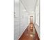 Long walk-in closet with custom white cabinets, drawers, and hardwood floors at 11 Church St, Charleston, SC 29401