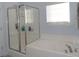 Bathroom features separate shower and tub with large window, tile floors and modern fixtures at 113 Mayfield Dr, Goose Creek, SC 29445