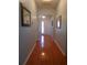 Inviting hallway with shiny hardwood floors and an arched entryway at 113 Mayfield Dr, Goose Creek, SC 29445