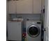 Convenient laundry room with a modern washer and dryer, storage cabinets, and cleaning supplies at 113 Mayfield Dr, Goose Creek, SC 29445