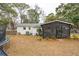 Exterior view of a home with a screened-in porch and spacious backyard with trampoline at 1149 Oxbow Dr, Charleston, SC 29412