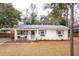 Charming single-story brick home featuring a welcoming front porch and freshly landscaped yard at 1149 Oxbow Dr, Charleston, SC 29412