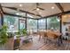 Inviting screened porch with a brick floor, ceiling fan, and plenty of seating for outdoor enjoyment at 1149 Oxbow Dr, Charleston, SC 29412