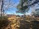 Large backyard with mature trees, and lush greenery that surrounds a traditional brick home at 116 Lyle Rd, Goose Creek, SC 29445