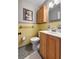 Bathroom with a white toilet, wooden cabinets, yellow tile walls, and a gray mosaic tile floor at 116 Lyle Rd, Goose Creek, SC 29445