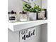 Bathroom decor shelf featuring plants, candles, and storage jars at 116 Lyle Rd, Goose Creek, SC 29445