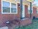 Exterior view of a home showcasing the entrance, brick siding, and a small porch area at 116 Lyle Rd, Goose Creek, SC 29445