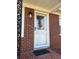 Front door with glass, decorative molding, brick siding and light fixture at 116 Lyle Rd, Goose Creek, SC 29445