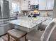 Close-up of kitchen island with granite countertop and seating in modern updated kitchen at 116 Lyle Rd, Goose Creek, SC 29445
