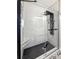 Modern shower with black trim, white subway tile, and black hexagonal floor tiles at 116 Lyle Rd, Goose Creek, SC 29445