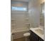 Bright bathroom featuring a tub-shower combination, vanity with sink, and a large mirror providing a functional space at 119 Palfrey Dr, Ridgeville, SC 29472
