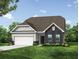 A digitally enhanced image shows a beautifully landscaped lawn and stone facade on this new home with a two-car garage at 119 Palfrey Dr, Ridgeville, SC 29472