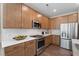 This is a modern kitchen with stainless steel appliances, white backsplash and wood cabinets at 119 Palfrey Dr, Ridgeville, SC 29472