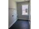 A well-lit laundry room with hexagon tile flooring and a window at 119 Palfrey Dr, Ridgeville, SC 29472