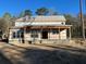 Under-construction exterior with inviting covered porch and classic window design, awaiting final finishes at 1302 Mccrae Dr Dr, Moncks Corner, SC 29461