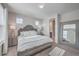 A well-lit bedroom featuring a comfortable bed, stylish furniture, and a large mirror at 131 Summer Tanager Dr, Ravenel, SC 29470