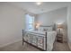 Bright bedroom with a metal frame bed, carpet, and a side table with a lamp at 131 Summer Tanager Dr, Ravenel, SC 29470
