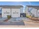 A modern home featuring a two-car garage, a neatly paved driveway and well-manicured landscaping at 131 Summer Tanager Dr, Ravenel, SC 29470