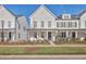 Charming two-story townhome with a manicured lawn and welcoming front porch at 131 Summer Tanager Dr, Ravenel, SC 29470