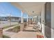 Covered front porch featuring brick pillars and a cozy seating area with views of the neighborhood at 131 Summer Tanager Dr, Ravenel, SC 29470
