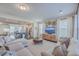 Open concept living room with modern decor, and an adjacent kitchen featuring a center island at 131 Summer Tanager Dr, Ravenel, SC 29470