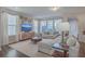 Bright living room with a neutral color palette, modern decor, and large windows for natural light at 131 Summer Tanager Dr, Ravenel, SC 29470