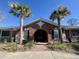 Community clubhouse featuring a brick facade, arched entryway, and palm trees at 1403 Cambridge Lakes Dr, Mount Pleasant, SC 29464