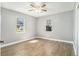 Bright bedroom featuring neutral paint, two windows and wood-look floors and a ceiling fan with light at 141 Cannon Ave, Goose Creek, SC 29445