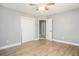 Bedroom with wood-look flooring, neutral walls, closet, and ceiling fan at 141 Cannon Ave, Goose Creek, SC 29445