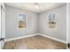 Bedroom with wood-look flooring, neutral walls, and windows overlooking the backyard at 141 Cannon Ave, Goose Creek, SC 29445