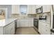 Bright kitchen features white cabinets, granite counters and stainless steel appliances at 141 Cannon Ave, Goose Creek, SC 29445