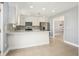 Modern kitchen with stainless steel appliances, gray backsplash, and white cabinets at 141 Cannon Ave, Goose Creek, SC 29445
