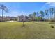 Wide shot of a home's extensive, grassy backyard with mature trees at 144 Clark Ln, Summerville, SC 29483