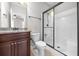 Bathroom with granite countertop, dark cabinetry and glass-enclosed shower at 144 Clark Ln, Summerville, SC 29483