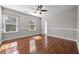 Spacious bedroom showcasing hardwood floors and large bright windows at 144 Clark Ln, Summerville, SC 29483