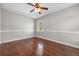 Cozy bedroom featuring hardwood floors, ceiling fan, and a view of backyard at 144 Clark Ln, Summerville, SC 29483