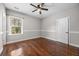 Comfortable bedroom featuring hardwood floors, ceiling fan, and a bright window at 144 Clark Ln, Summerville, SC 29483